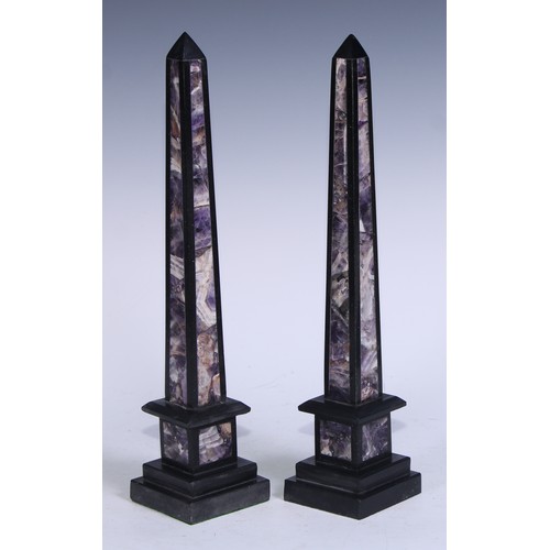 5170 - A pair of amethyst quartz and black marble library obelisks, stepped bases, 40cm high