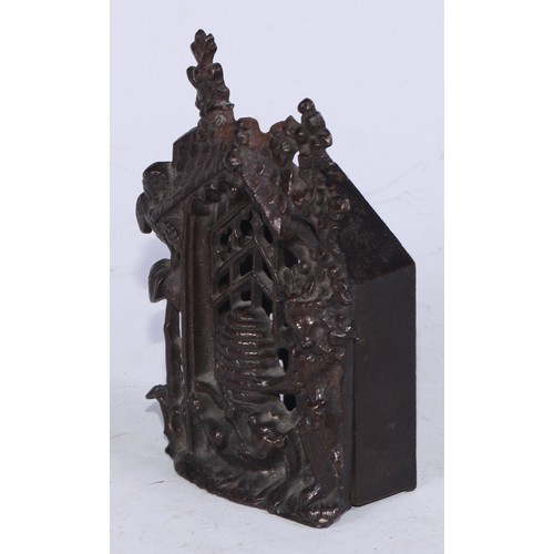 5215 - A Victorian cast iron money box, cast as a bear at a beehive, within a Gothic niche, 14cm high, Rd. ... 