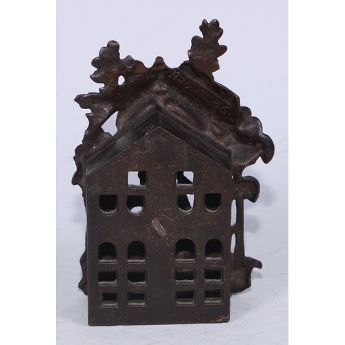 5215 - A Victorian cast iron money box, cast as a bear at a beehive, within a Gothic niche, 14cm high, Rd. ... 