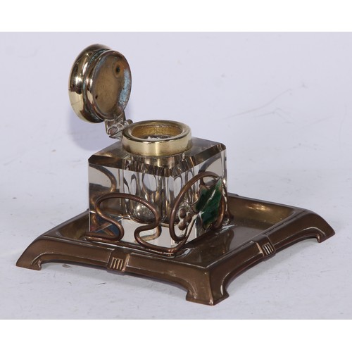 5246 - An Art Nouveau brass and enamel square inkstand, decorated with an ivy leaf, the glass well with hin... 