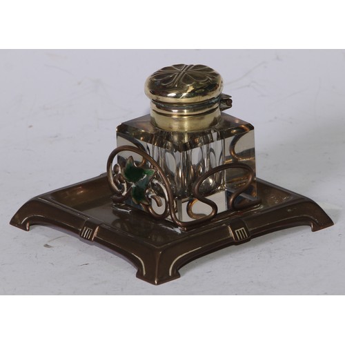 5246 - An Art Nouveau brass and enamel square inkstand, decorated with an ivy leaf, the glass well with hin... 