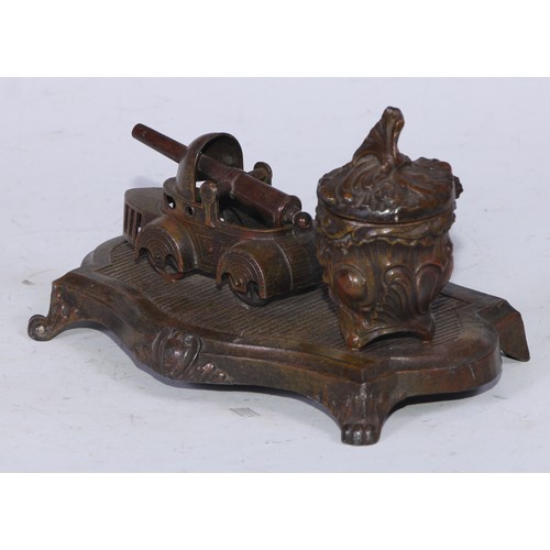 5254 - An early 20th century cold painted spelter novelty inkstand, the Rococo Revival well set beside a mo... 