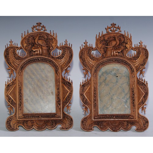 5173 - A pair of Chinese sandalwood easel photograph frames, each carved with fanciful birds, stiff leaves,... 