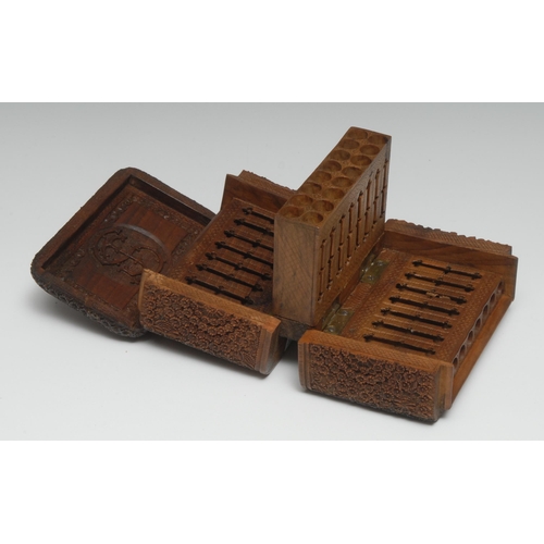 5272 - An Indian hardwood folding cigarette box, profusely carved in relief with stylised lotus, folding in... 