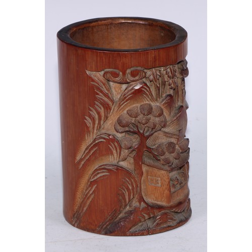 5067 - A Chinese bamboo bitong brush pot, carved in relief with figures and pagodas in a monumental landsca... 