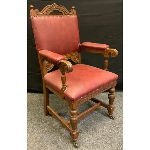 45 - A set of eight Gothic revival oak dining chairs (six chairs and two carvers), red leather backs and ... 