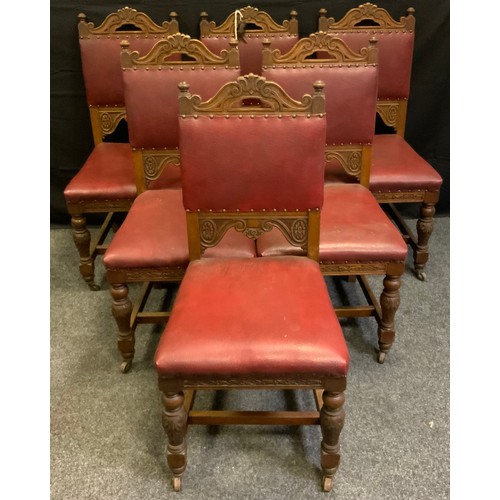 45 - A set of eight Gothic revival oak dining chairs (six chairs and two carvers), red leather backs and ... 