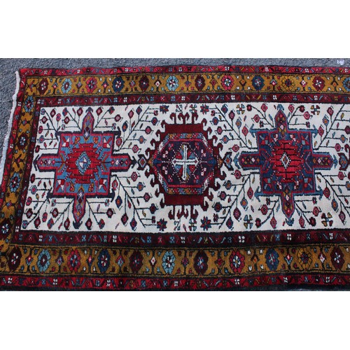 50 - A Persian hand-made Heriz runner, 332cm x 96cm