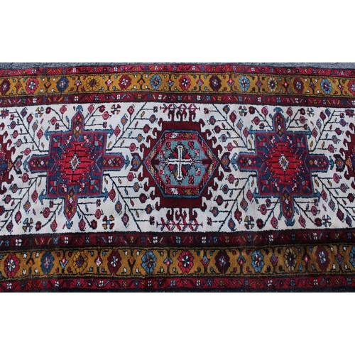 50 - A Persian hand-made Heriz runner, 332cm x 96cm