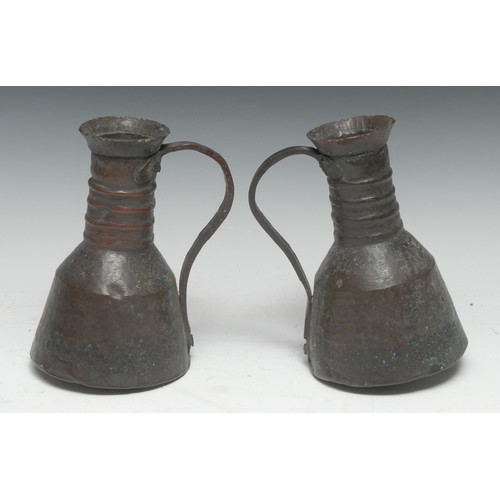 5280A - A pair of Islamic planished copper ewers, four-girdle necks, loop handles, 17.5cm high, Persia/Iran