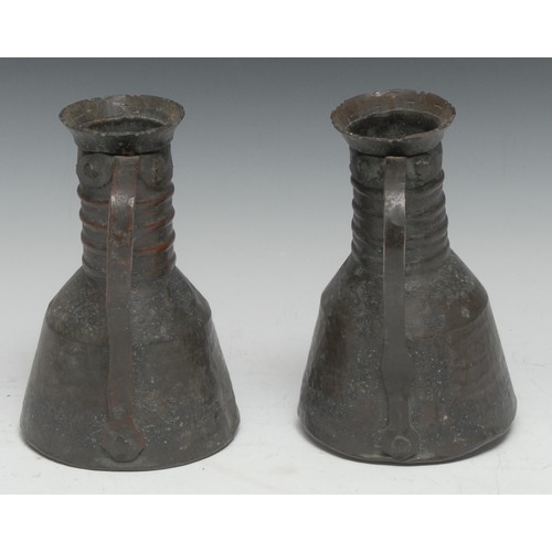 5280A - A pair of Islamic planished copper ewers, four-girdle necks, loop handles, 17.5cm high, Persia/Iran