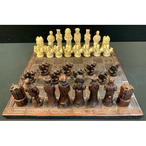 71 - An Elizabethan style figural Chess set, King 12.7cm high, carved board