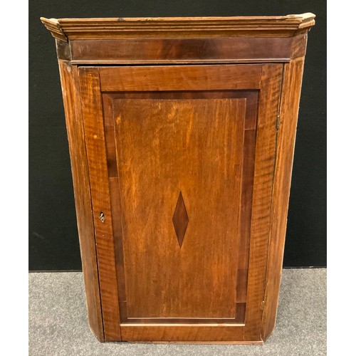 102 - A George III oak corner cupboard, moulded cornice, the field panelled door inlaid with mahogany loze... 