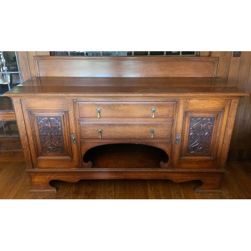 68 - An Edwardian oak sideboard, fitted with two drawers, and two panelled doors, carved with scrolls, 11... 