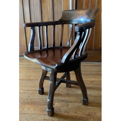 70 - An early 20th century mahogany office swivel chair, shaped spindle back and seat, c.1900


** We wou... 