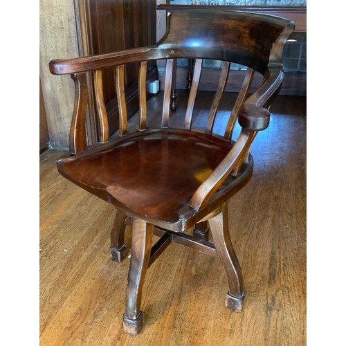 70 - An early 20th century mahogany office swivel chair, shaped spindle back and seat, c.1900


** We wou... 