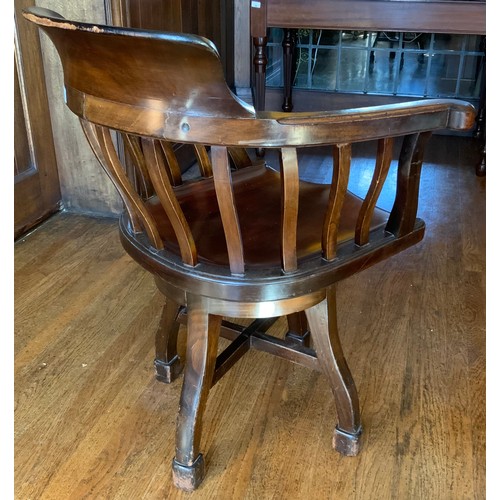 70 - An early 20th century mahogany office swivel chair, shaped spindle back and seat, c.1900


** We wou... 