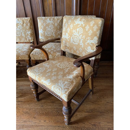 75 - A set of twelve oak dining chairs, by Thomas Turner of Manchester, stuffed over back and seats, flut... 