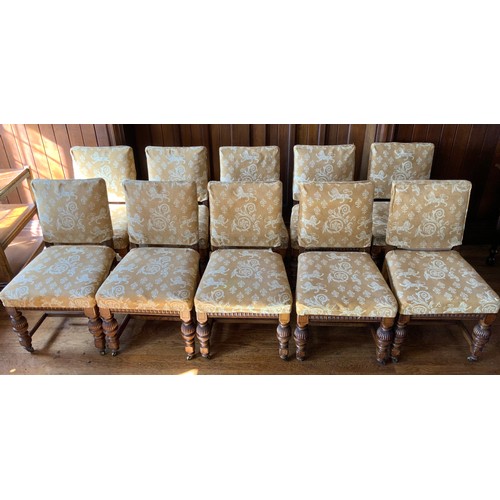 75 - A set of twelve oak dining chairs, by Thomas Turner of Manchester, stuffed over back and seats, flut... 