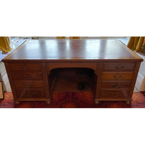 27 - A late 19th/early 20th century mahogany partners desk, tooled leather writing surface, central drawe... 