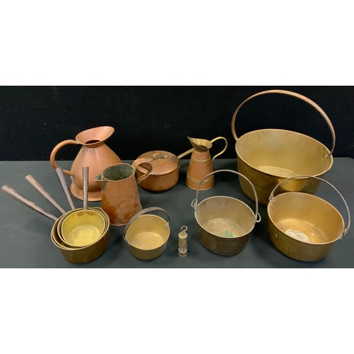 116 - A large brass jam pan;  others, smaller;  a graduated set of four saucepans;  copper haystack jug;  ... 