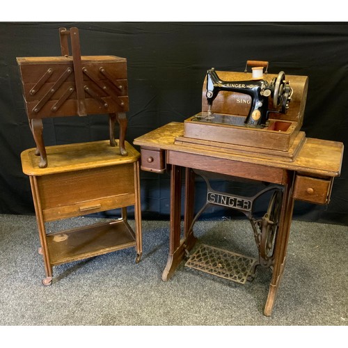 151 - A Singer manual wind portable sewing machine, oak case;  another treadle table mounted;  two sewing ... 