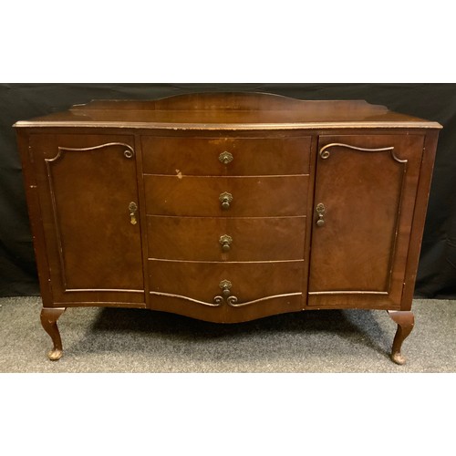 159 - A serpentine front mahogany sideboard, oversailing top above three short drawers flanked by a pair o... 