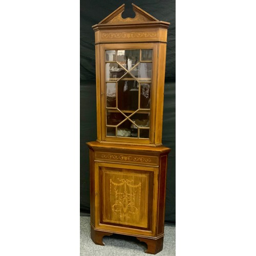 160 - A Sheratan revival inlaid mahogany floor standing corner cabinet, shaped pediment above single astra... 