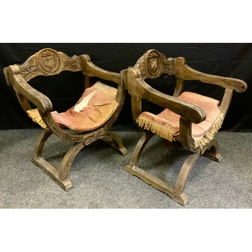 161 - A pair of oak X-frame 'Bishop' chairs, the backs carved with a shield, c.1870