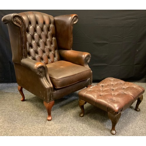 172 - A button wing back chair, deep button back, cabriole legs;  conforming foot stool