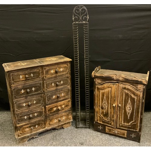 174 - An Ethnic ten drawer chest, 75cm high, 60cm wide;  a similar side cabinet, 65cm high, 48cm wide;  a ... 