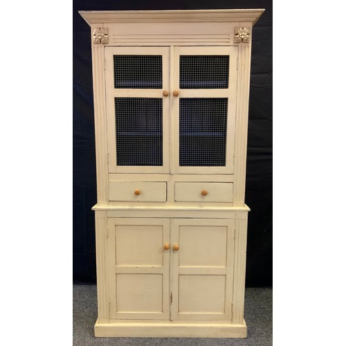 181 - A shabby chic white painted kitchen cabinet, the top with wire work doors, the base with cupboard do... 