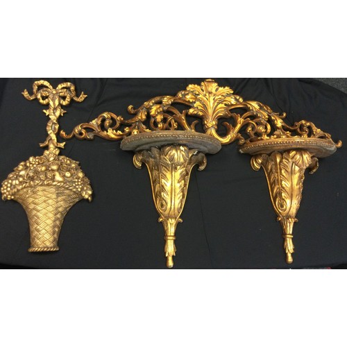 115 - A carved gilt leafy bracket, 127cm long;  two gilt wall brackets;  etc (4)