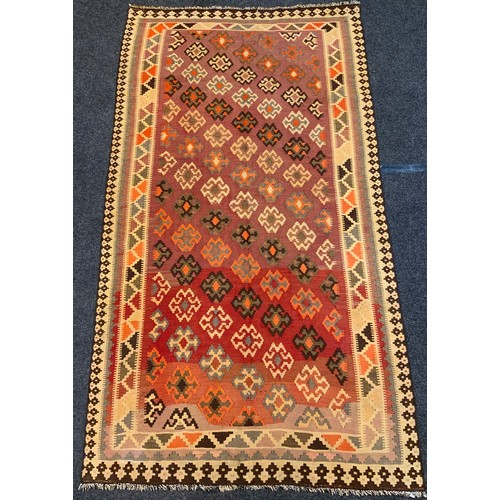 70A - A Qashgai Kilim woolen rug, the large central field woven with diagonal bands of stylized geometric ... 