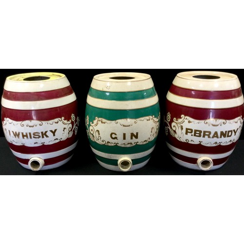 206 - A Staffordshire pottery barrel, inscribed P. Brandy, banded in maroon, 33cm high, c.1860;  others, I... 