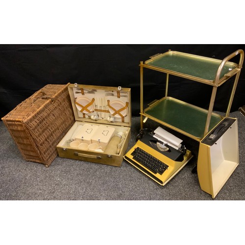 208 - A mid 20th century picnic set;  a wicker hamper;  a gilt two tier trolley;  a typewriter (4)