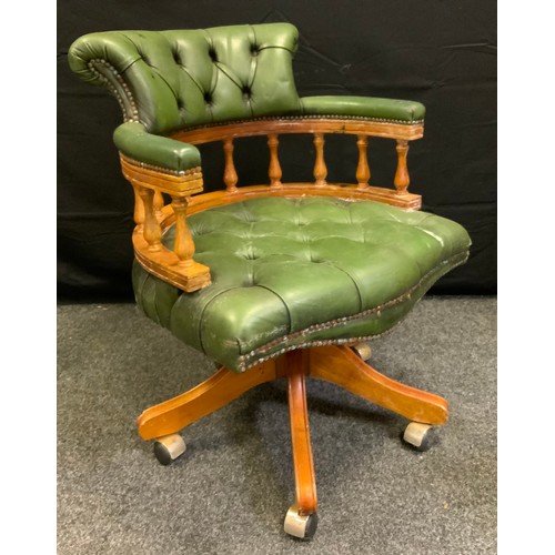 210 - A 20th century swivel office chair, green button back