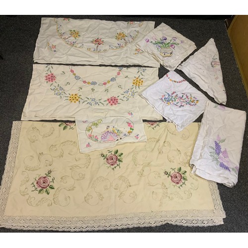 82A - Hand embroidered linen table cloths, including crinoline lady, English country flowers, etc