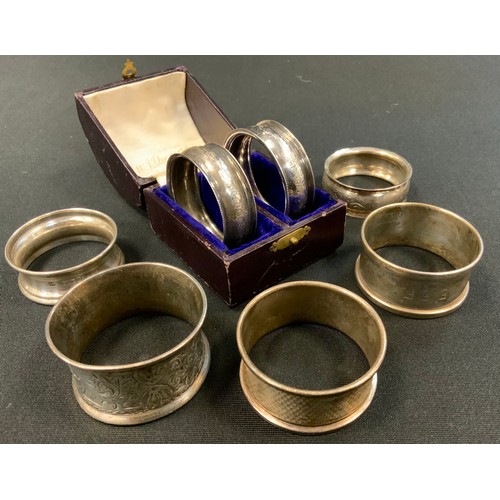 221 - A pair of George V silver napkin rings, Birmingham 1911/12, boxed;  others loose various 67.6g gross... 