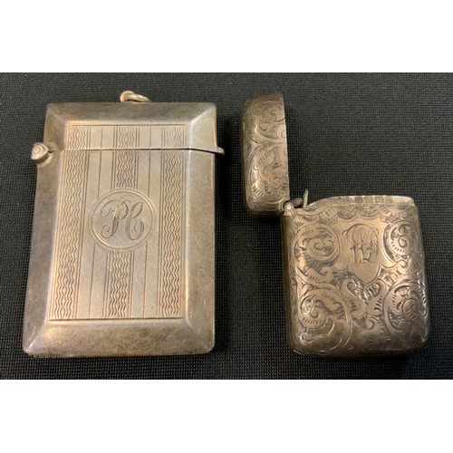 247 - A silver vesta case, engraved and chased with scrolling foliage, c.1900;   another engine turned in ... 