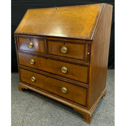 178 - An early 19th century oak bureau, fall-door to top enclosing small cupboard flanked by four pairs of... 