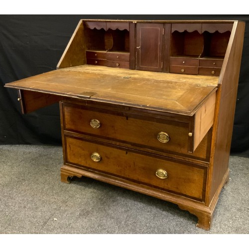 178 - An early 19th century oak bureau, fall-door to top enclosing small cupboard flanked by four pairs of... 