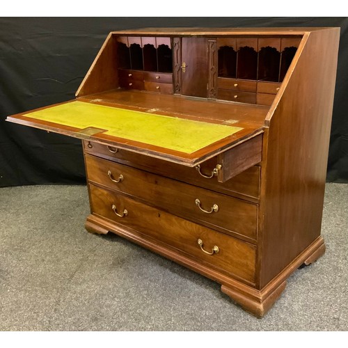 179 - An early 19th century mahogany bureau, the fall-door top enclosing a small cupboard door, flanked by... 