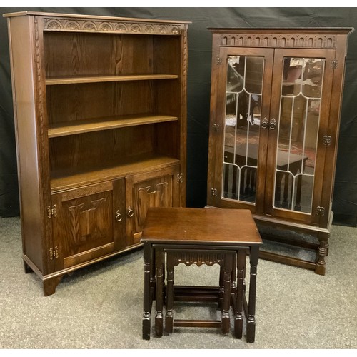 180 - A Jaycee dark oak bookcase cabinet, having a pair of leaded, glazed doors enclosing two tiers of she... 