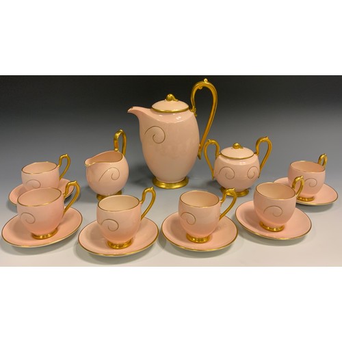 73 - A Carlton Ware coffee service, for six, in pink with gilt scroll, gilt handles, comprising coffee po... 