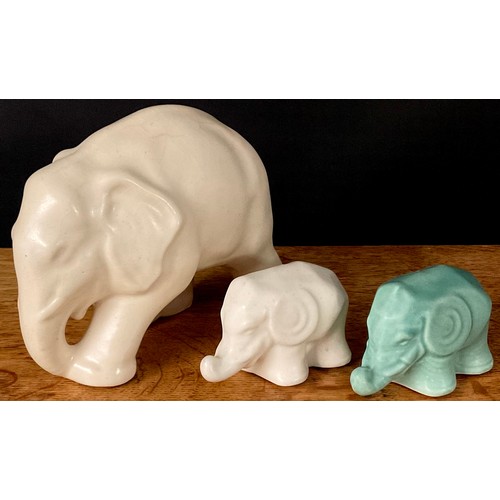85 - A Lovatts Langley elephant, in cream, 14cm high; two other stylised elephants, in cream and green, e... 