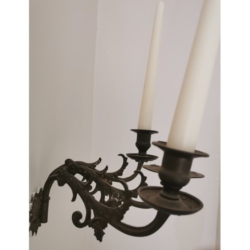 337 - A late 19th/early 20th century brass three light wall sconce, circular nozzles, spool shaped sconces... 