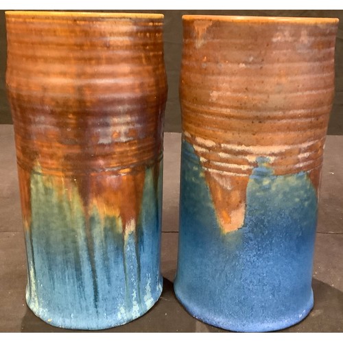 59 - A pair of Bourne Denby Danesby Orient Ware Brassington ribbed cylindrical vases, 23cm, printed marks... 