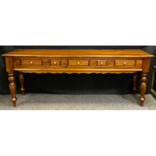 333 - A 20th century mahogany console table, rounded rectangular over-sailing top above an arrangement of ... 