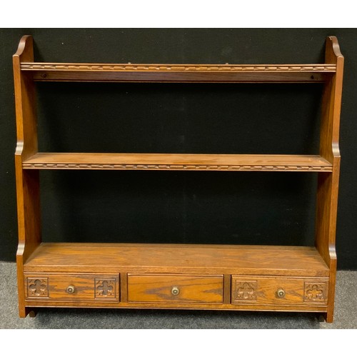 334 - A 20th century oak wall hanging shelves, three graduated open shelves above three frieze drawers, 96... 